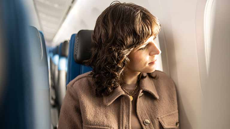 Woman sitting on plane Woman sitting on plane