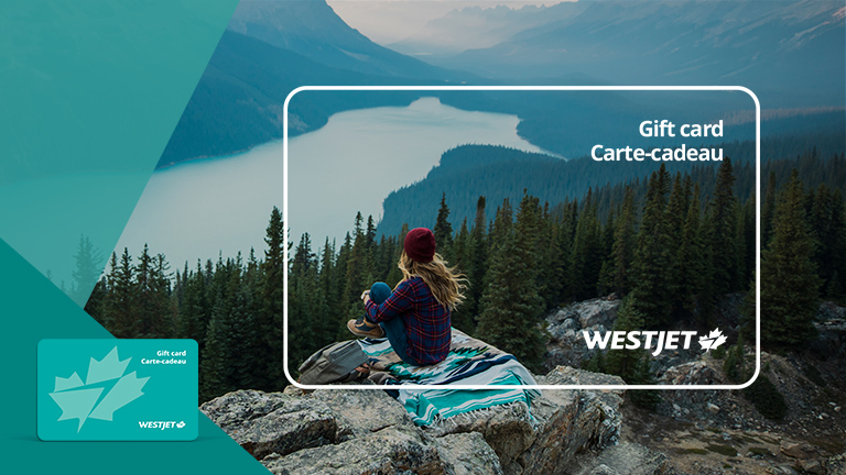 Woman sitting overlooking mountain lake