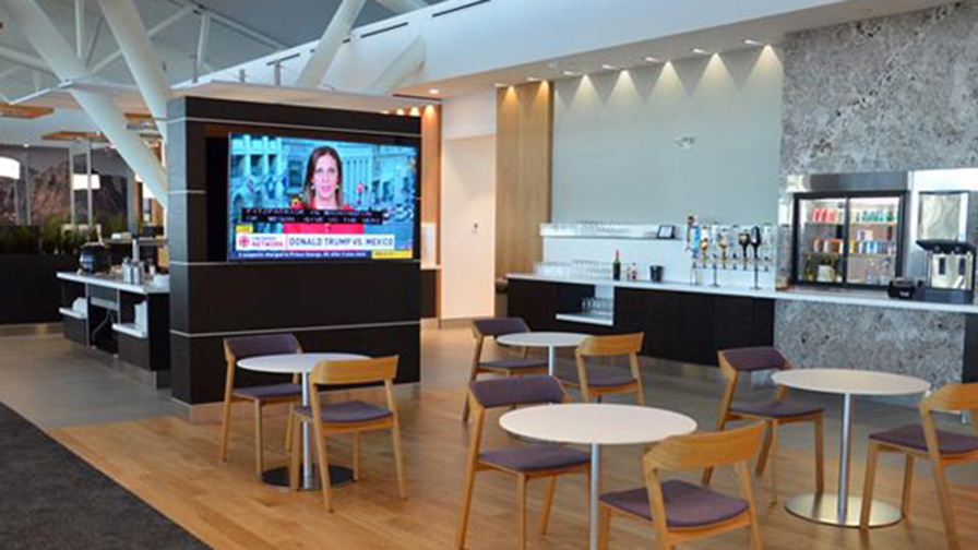 TV and seating in Aspire Lounge International in Concourse D in Calgary Airport