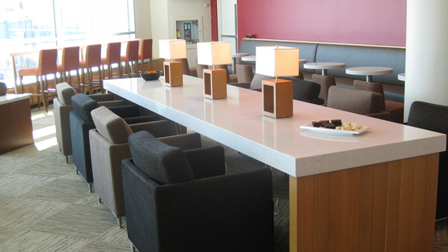 Comfortable seating at a long table in the Plaza Premium Lounge in YYZ