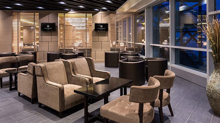 Velvet seats by the window in the Plaza Premium Lounge in US departures Vancouver Airport